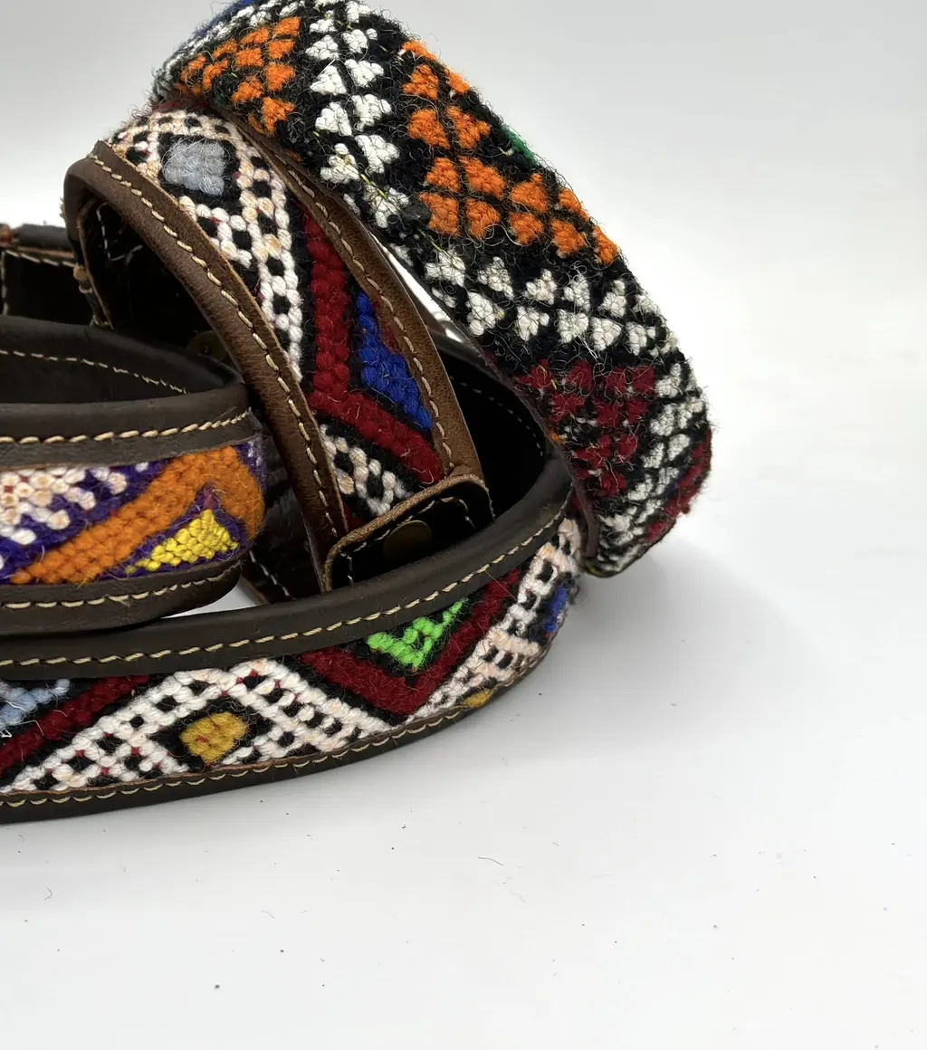 BohoBarks collars curled together, showing orange-and-white and crimson kilim bands in stitched leather