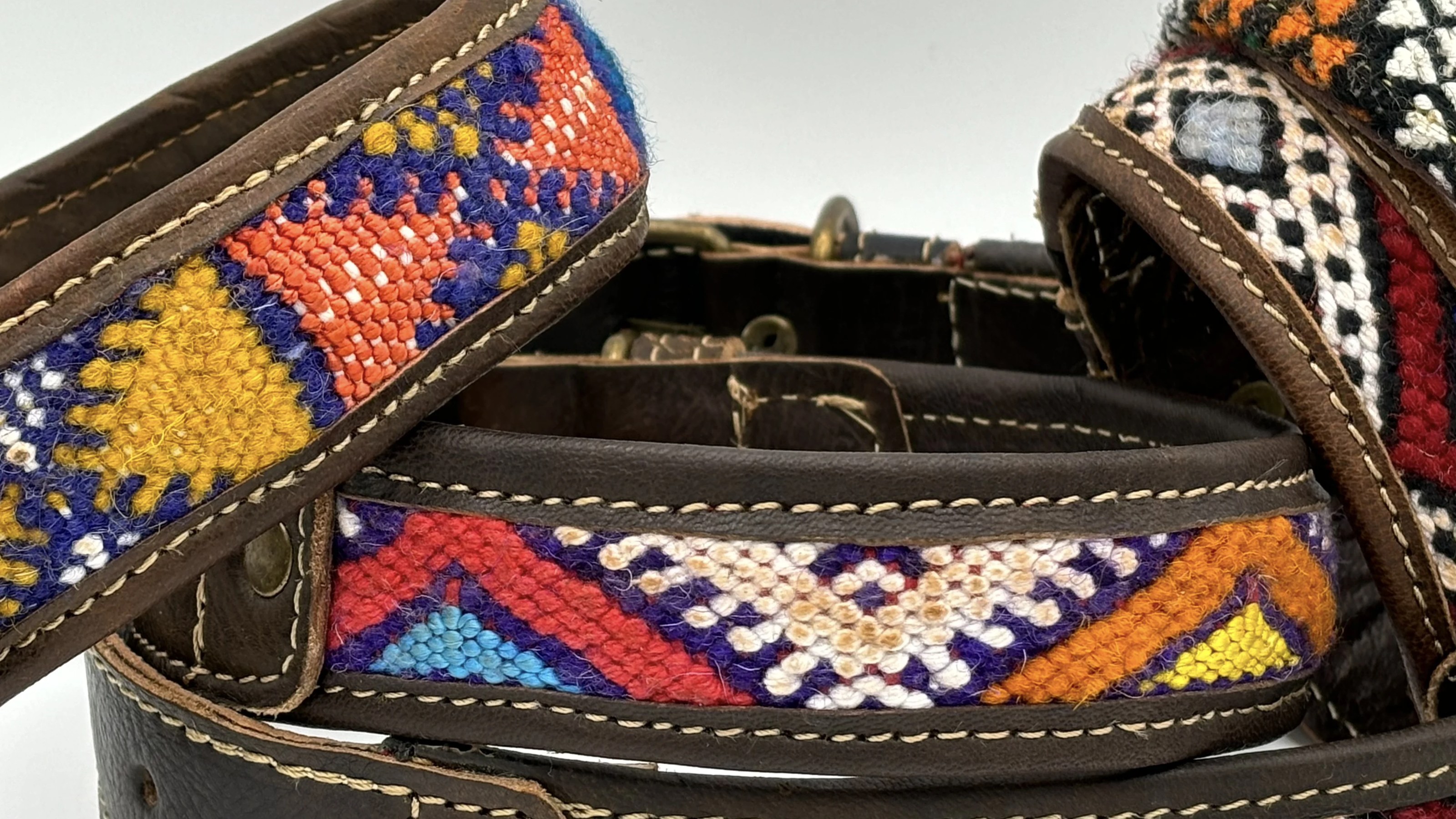 A tight stack of BohoBarks collars showing three different kilim patterns