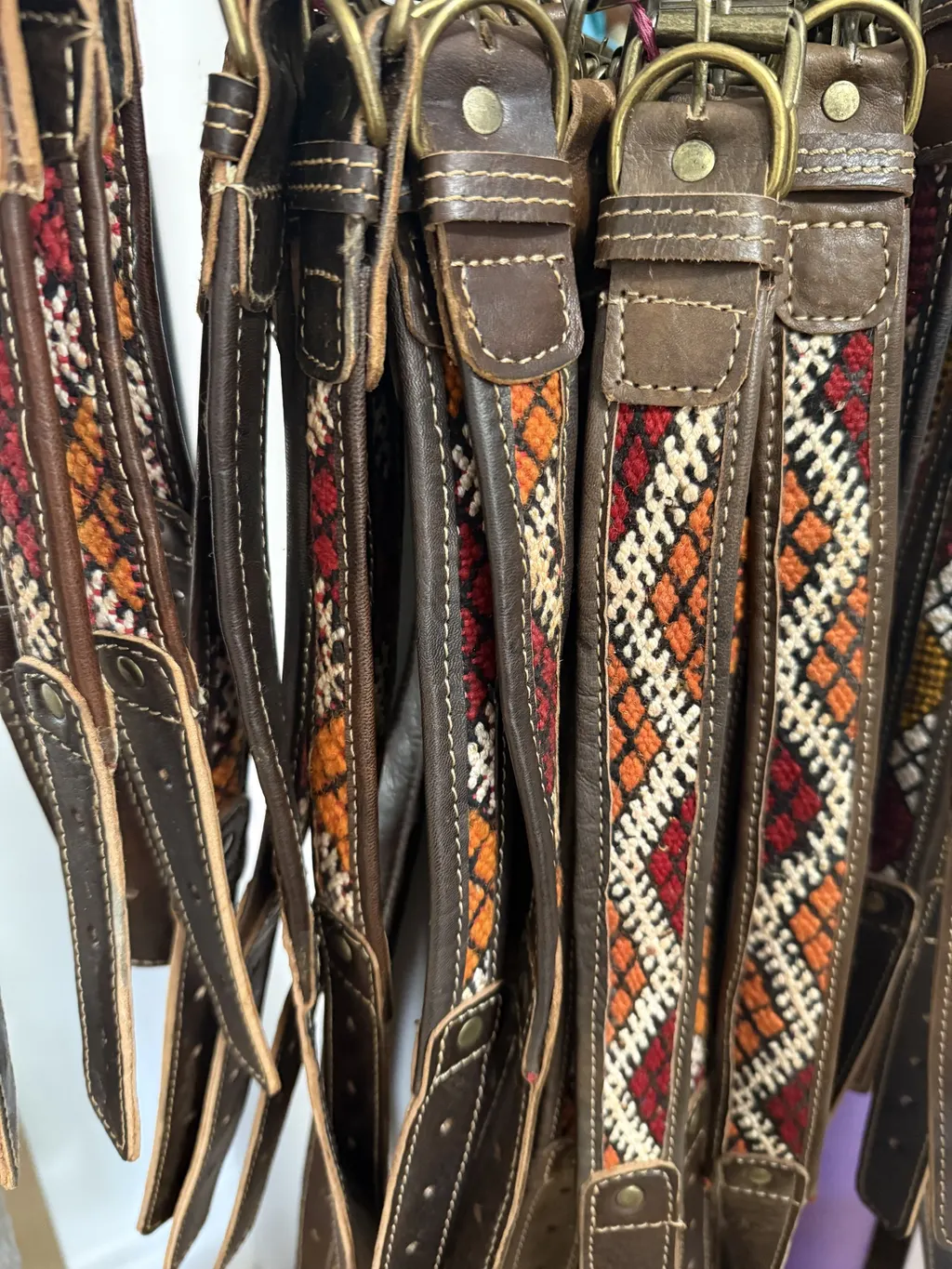 Assorted BohoBarks collars hanging together, showing different kilim zigzag patterns